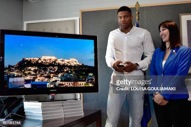 All-Star and Milwaukee Bucks forward Giannis Antetokounmpo and Greek Tourism Minister Elena Kountoura watch a new ad campaign featuring the star...
