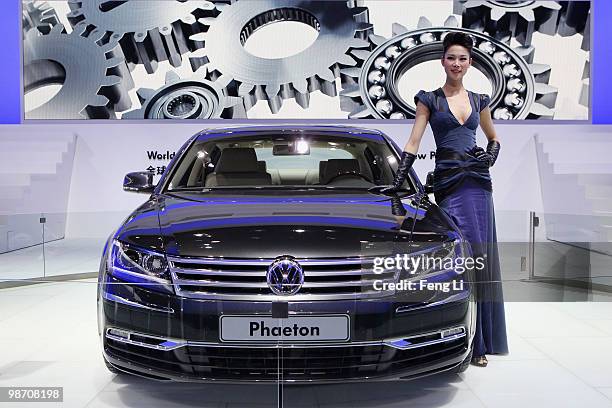 Model stands beside the world premiere display of Volkswagen new Phaeton during the Beijing Auto Show on April 27, 2010 in Beijing of China. Major...
