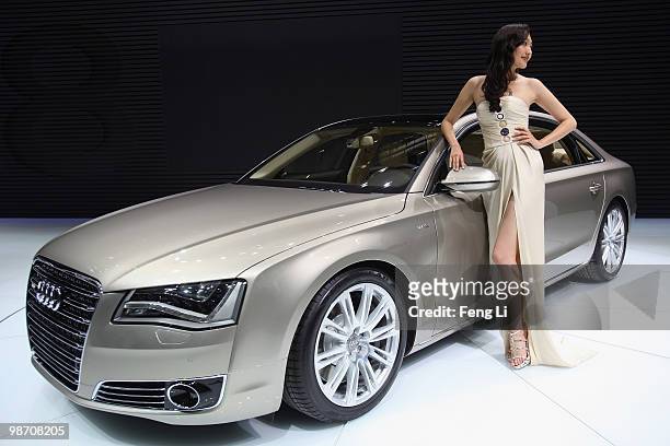 Model stands beside a Audi A8L during the Beijing Auto Show on April 27, 2010 in Beijing of China. Major global automakers plan to unveil dozens of...