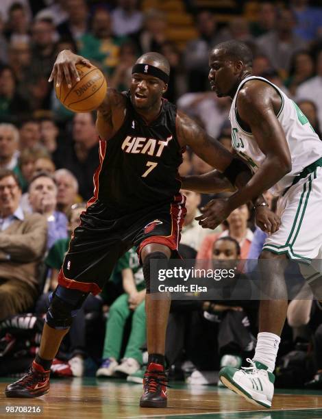 Jermaine O'Neal of the Miami Heat tries to hang on to the ball as Kendrick Perkins of the Boston Celtics defends during Game Five of the Eastern...