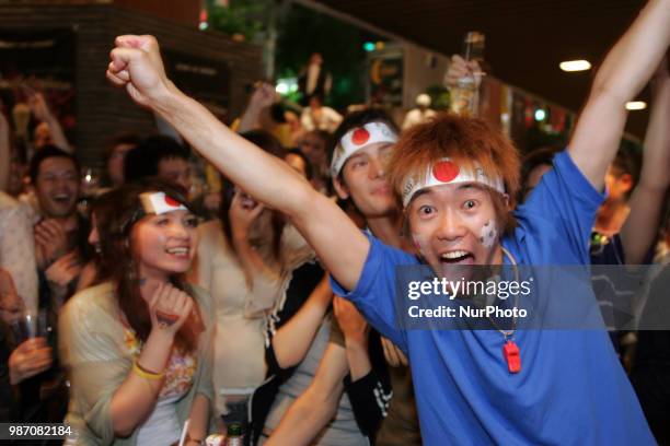 Japanese fans react as they watch a broadcast of the World Cup Group H soccer match Japan vs Poland, at a sports bar in Tokyo, Japan, June 29, 2018.