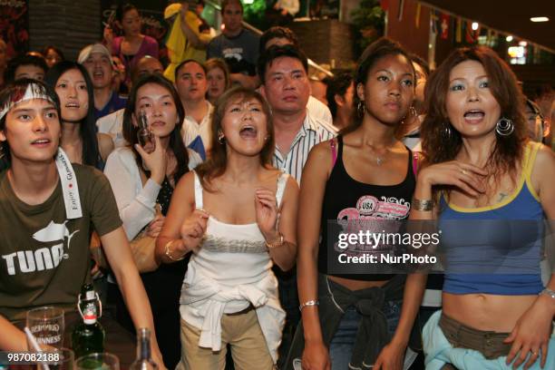 Japanese fans react as they watch a broadcast of the World Cup Group H soccer match Japan vs Poland, at a sports bar in Tokyo, Japan, June 29, 2018.