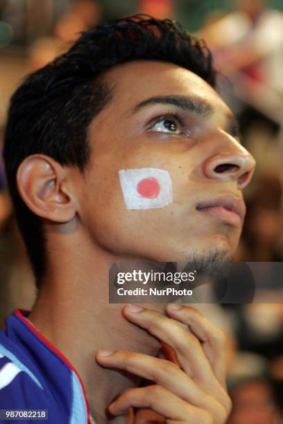 Japanese fans react as they watch a broadcast of the World Cup Group H soccer match Japan vs Poland, at a sports bar in Tokyo, Japan, June 29, 2018.