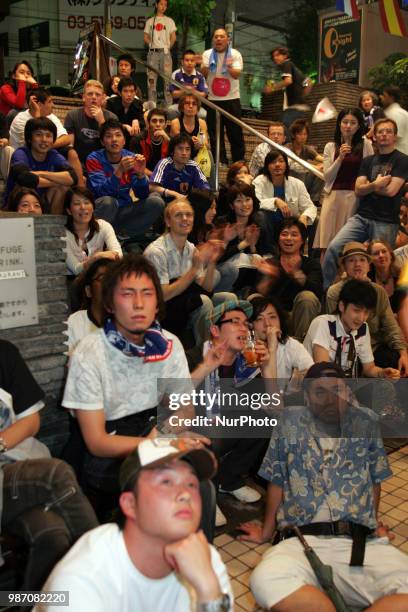 Japanese fans react as they watch a broadcast of the World Cup Group H soccer match Japan vs Poland, at a sports bar in Tokyo, Japan, June 29, 2018.