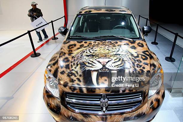 Visitor looks at the Dodge Caliber during the Beijing Auto Show on April 27, 2010 in Beijing of China. Major global automakers plan to unveil dozens...