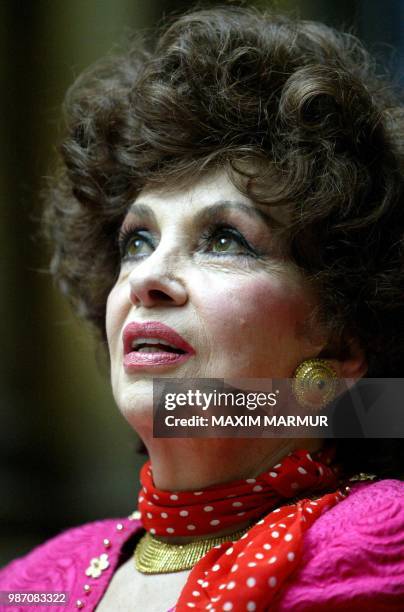 Italian actress Gina Lollobrigida reacts as she answers journalists questions during the news conference before opening of her sculpture exhibition...