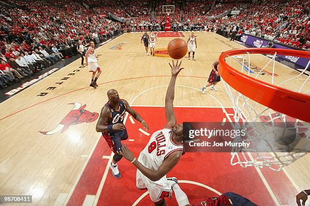 Luol Deng of the Chicago Bulls puts a shot up against Shaquille O'Neal of the Cleveland Cavaliers during Game Three of the Eastern Conference...