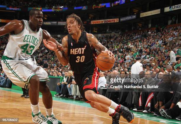 Michael Beasley of the Miami Heat drives against Kendrick Perkins of the Boston Celtics in Game Five of the Eastern Conference Quarterfinals during...