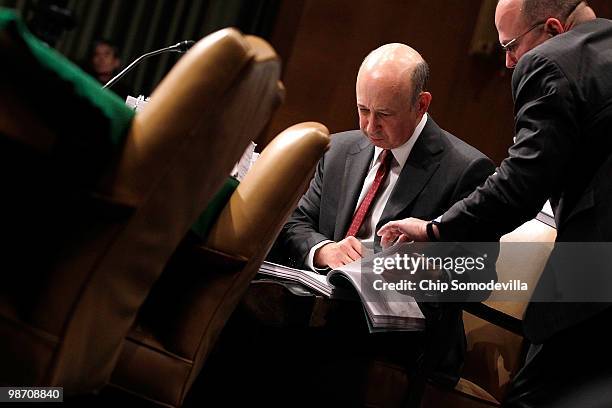 Lloyd Blankfein, chairman and CEO of The Goldman Sachs Group, looks through exhibit documents while testifying before the Senate Homeland Security...