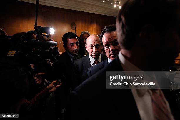 Lloyd Blankfein , chairman and CEO of The Goldman Sachs Group, pushes through a crowd of journalists after testifying before the Senate Homeland...