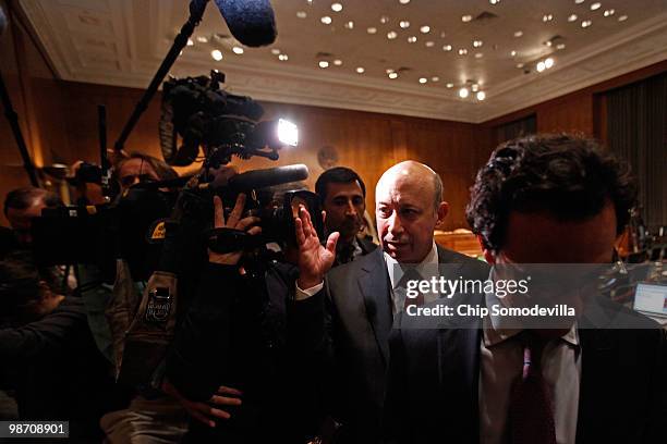 Lloyd Blankfein , chairman and CEO of The Goldman Sachs Group, pushes a television camera out of his face after testifying before the Senate Homeland...