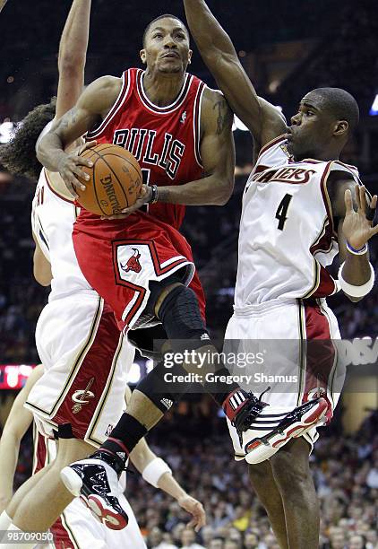 Derrick Rose of the Chicago Bulls goes up for a shot against Antawn Jamison and Anderson Varejao of the Cleveland Cavaliers in Game Five of the...