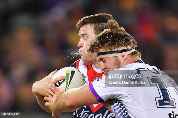 Luke Keary of the Roosters and Christian Welch of the Storm compete for the ball during the round 16 NRL match between the Sydney Roosters and the...