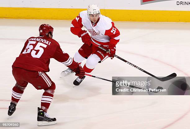 Valtteri Filppula of the Detroit Red Wings skates with the puck under pressure from Ed Jovanovski of the Phoenix Coyotes in Game Seven of the Western...