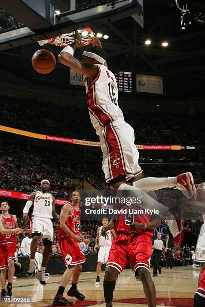 Jamario Moon of the Cleveland Cavaliers finishes an ally oop dunk passed by LeBron James while defended by Luol Deng of the Chicago Bulls in Game...