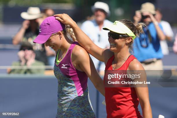 Kirsten Flipkens of Belgium and Johanna Larsson of Sweden celebrate their victory after they beat Alicja Rosolska of Poland and Abigail Spears of USA...