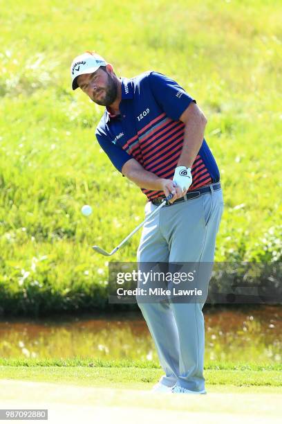 Marc Leishman of Australia plays a shot on to the 14th green during the second round of the Quicken Loans National at TPC Potomac on June 29, 2018 in...