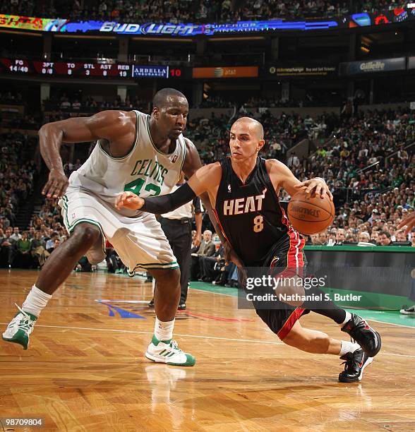 Carlos Arroyo of the Miami Heat drives against Kendrick Perkins of the Boston Celtics in Game Five of the Eastern Conference Quarterfinals during the...