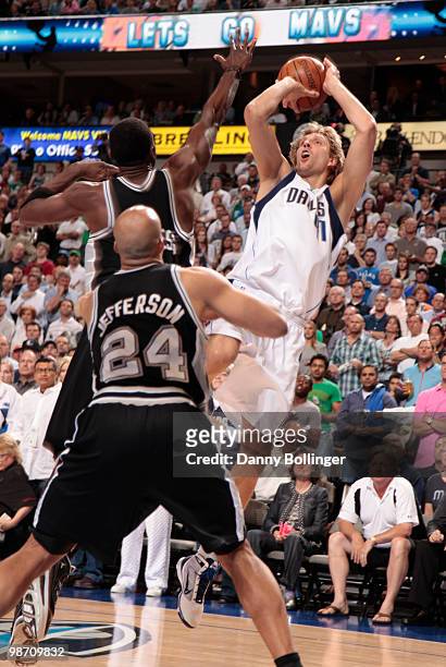 Dirk Nowitzki of the Dallas Mavericks shoots a jumper against Antonio McDyess and Richard Jefferson of the San Antonio Spurs in Game Five of the...