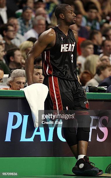 Dwyane Wade of the Miami Heat waits near the scorer's table as Ray Allen of the Boston Celtics shoots three free throws during Game Five of the...