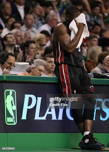 Dwyane Wade of the Miami Heat waits near the scorer's table as Ray Allen of the Boston Celtics shoots three free throws during Game Five of the...