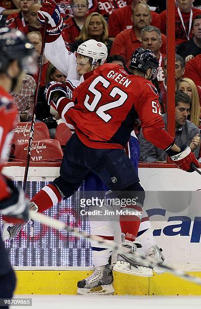 Mike Green of the Washington Capitals checks Travis Moen of the Montreal Canadiens in Game Five of the Eastern Conference Quarterfinals during the...