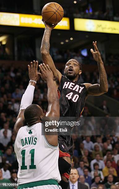 Udonis Haslem of the Miami Heat takes a shot as Glen Davis of the Boston Celtics defends during Game Five of the Eastern Conference Quarterfinals of...