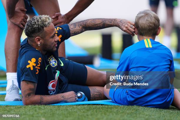 Neymar Jr talks to his son Davi Lucca da Silva Santos during a Brazil training session on June 29, 2018 in Sochi, Russia.