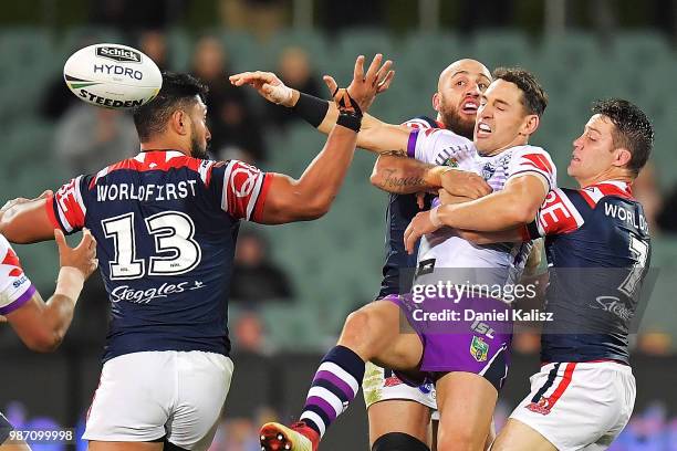 Billy Slater of the Storm passes the ball during the round 16 NRL match between the Sydney Roosters and the Melbourne Storm at Adelaide Oval on June...