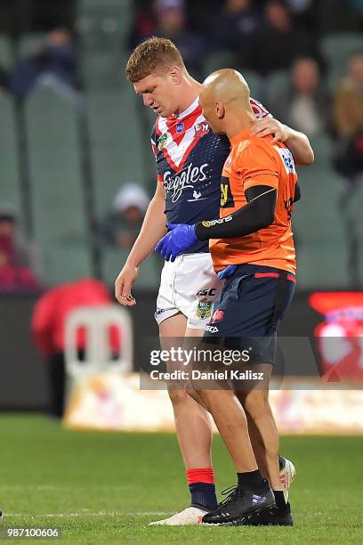 Dylan Napa of the Roosters is helped from the ground by trainers during the round 16 NRL match between the Sydney Roosters and the Melbourne Storm at...