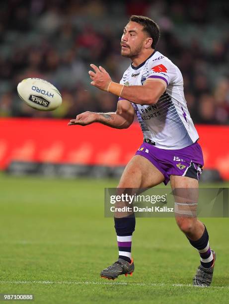 Cameron Smith of the Storm passes the ball during the round 16 NRL match between the Sydney Roosters and the Melbourne Storm at Adelaide Oval on June...