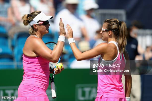 Alicja Rosolska of Poland and Abigail Spears of USA high five as they play against Kirsten Flipkins of Belgium and Johanna Larsson of Sweden in the...