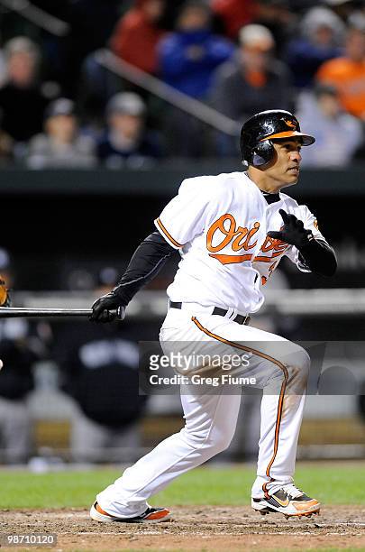 Cesar Izturis of the Baltimore Orioles drives in the winning run in the eighth inning against the New York Yankees at Camden Yards on April 27, 2010...