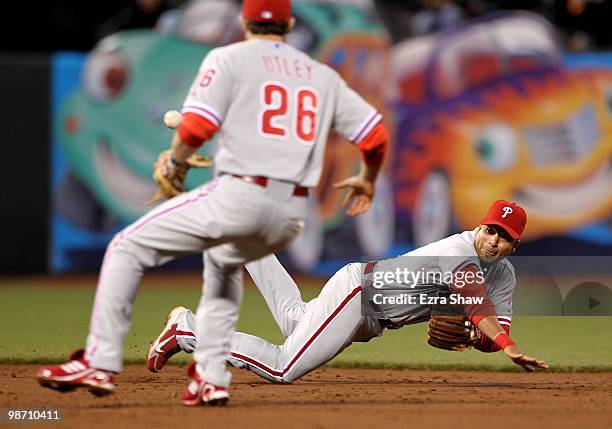 Juan Castro of the Philadelphia Phillies tosses the ball from his glove to Chase Utley that started a double play that ended the third inning of...