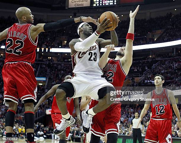 LeBron James of the Cleveland Cavaliers tries to get a shot off between Taj Gibson and Brad Miller of the Chicago Bulls in Game Five of the Eastern...