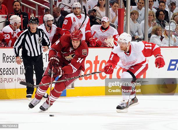 Taylor Pyatt of the Phoenix Coyotes skates with the puck against a defending Dan Cleary of the Detroit Red Wings in Game Seven of the Western...