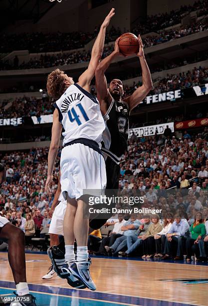 Tim Duncan of the San Antonio Spurs shoots a jumper against Dirk Nowitzki of the Dallas Mavericks in Game Five of the Western Conference...