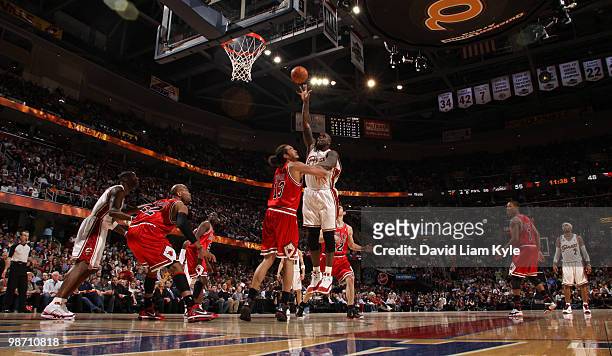 Shaquille O'Neal of the Cleveland Cavaliers shoots over Joakim Noah of the Chicago Bulls in Game Five of the Eastern Conference Quarterfinals at The...