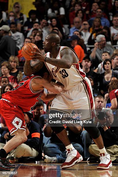 Shaquille O'Neal of the Cleveland Cavaliers leans in towards the basket against Joakim Noah of the Chicago Bulls in Game Five of the Eastern...