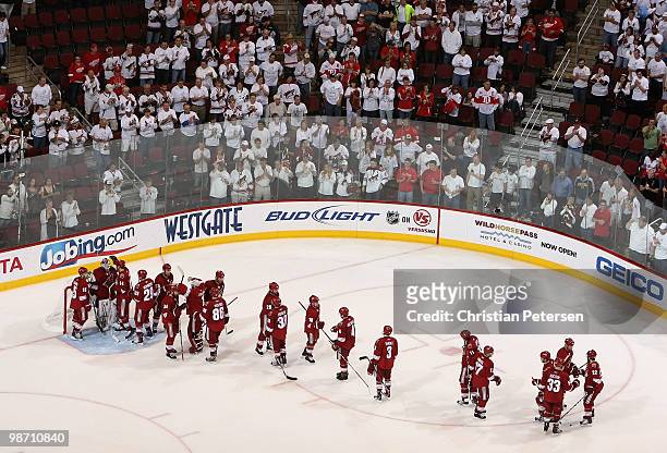 Goaltender Ilya Bryzgalov of the Phoenix Coyotes is greeted by teammates after being defeated by the Detroit Red Wings in Game Seven of the Western...