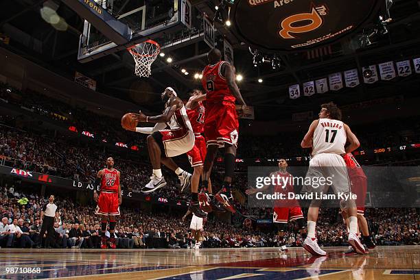 LeBron James of the Cleveland Cavaliers goes up for the shot against against Joakim Noah and Luol Deng of the Chicago Bulls in Game Five of the...