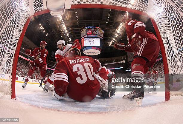 Patrick Eaves of the Detroit Red Wings and Keith Yandle of the Phoenix Coyotes battle for a loose puck in front of goaltender Ilya Bryzgalov in Game...