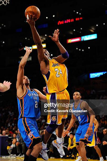 Kobe Bryant of the Los Angeles Lakers goes up for a shot between Thabo Sefolosha and Russell Westbrook of the Oklahoma City Thunder in the third...