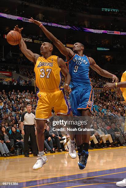 Ron Artest of the Los Angeles Lakers and Serge Ibaka of the Oklahoma City Thunder chase after a loose ball in Game Five of the Western Conference...