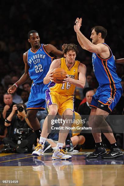 Pau Gasol of the Los Angeles Lakers makes a move in the paint between Jeff Green and Nenad Krstic of the Oklahoma City Thunder in Game Five of the...