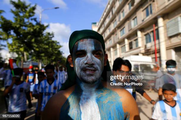 Bangladeshi football fans of Argentina waves the national flag of Argentina as they take part in rally ahead of France vs Argentina match in the FIFA...