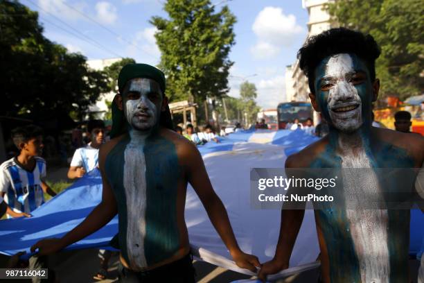 Bangladeshi football fans of Argentina waves the national flag of Argentina as they take part in rally ahead of France vs Argentina match in the FIFA...