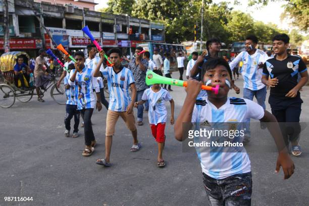 Bangladeshi football fans of Argentina waves the national flag of Argentina as they take part in rally ahead of France vs Argentina match in the FIFA...