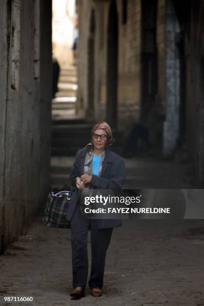 Woman walks in a street of the historical casbah distrisct in Algiers City 17 May 2006. Once a sparkling white medina, or Islamic city, perched on a...