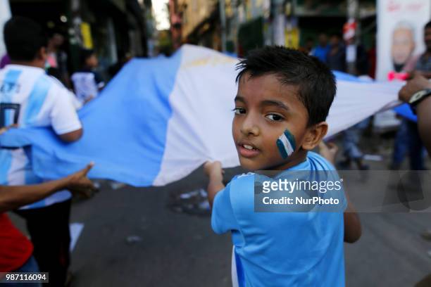 Bangladeshi football fans of Argentina waves the national flag of Argentina as they take part in rally ahead of France vs Argentina match in the FIFA...